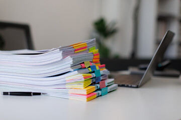Business Documents, Business woman working in Stacks of paper files for searching and checking unfinished document achieves on folders papers at busy work desk office
