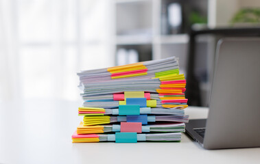 Document pile on office desk, Stack of business paper on the table with blurred of meeting room interior background. job interview and busy business concepts.
