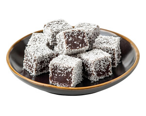 Chocolate lamingtons coated with desiccated coconut served on dark ceramic plate isolated on transparent background