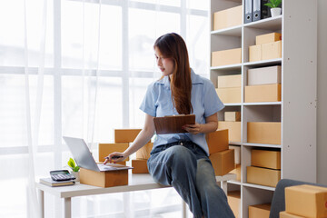 asian woman receive order on laptop. Startup small business entrepreneur SME, Success young Asian...