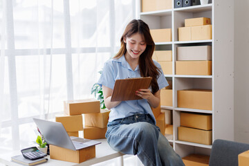 asian woman receive order on laptop. Startup small business entrepreneur SME, Success young Asian...
