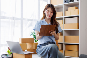 asian woman receive order on laptop. Startup small business entrepreneur SME, Success young Asian...