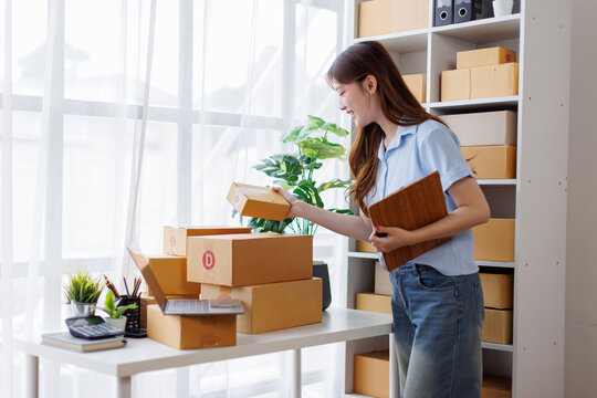 Asian woman entrepreneur taking notes while working on laptop a customer managing orders in her sme small business store. sme supply chain, procurement, omnichannel or coronavirus quarantine concept.
 - Powered by Adobe