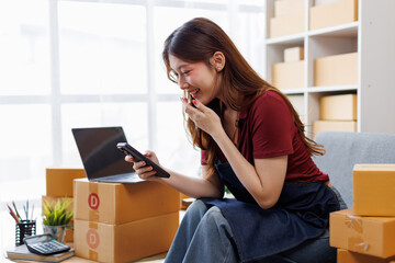 Young asia Small and Medium Enterprises (SMEs) seller woman happy work on laptop busy cellphone...