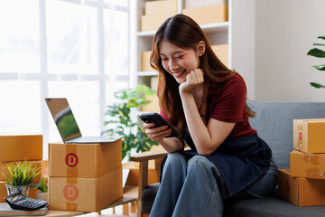 Young asia Small and Medium Enterprises (SMEs) seller woman happy work on laptop busy cellphone...