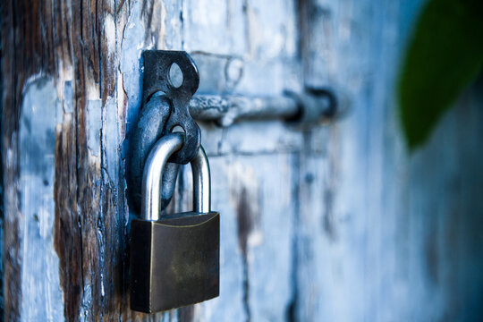Detail of padlocked bolt on a blue door