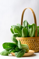Organic Bok choy or Pak choi on wooden plate and basket, Fresh vegetable, Food ingredient