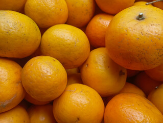 stunning close-up shot of a number of fresh, ripe oranges, showing off their bright color and textured skin, perfect for healthy eating