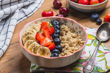 Oatmeal porridge with strawberries, blueberries and banana