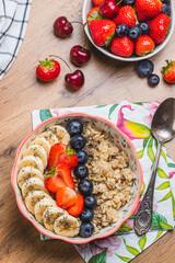 Oatmeal porridge with strawberries, blueberries and banana