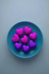 Heart-shaped macarons arranged on a teal plate