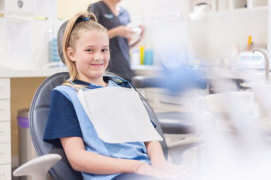 Tween girl at the dentist sitting in chair