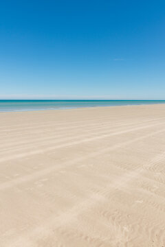 Empty beach with nothing but four wheel drive tyre tracks
