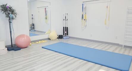 Bright Physical Therapy Room with Exercise Mat Ball and Modern Equipment Emphasizing Healthcare Wellness and Rehabilitation in a Clean and Airy Setting