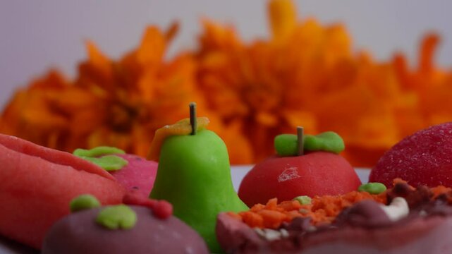 Close-up of fruit- and food-shaped sweets, Day of the Dead decorations in an offering, Mexico