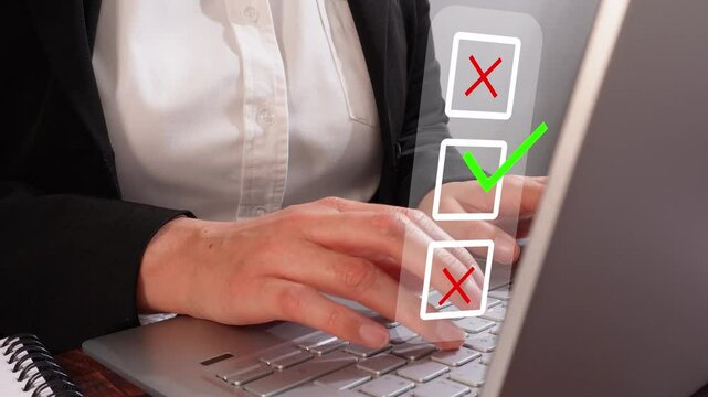 Close-up of a woman's hands checking off a list on a laptop screen, with a red X crossed out and a green check mark icon, representing a business concept.