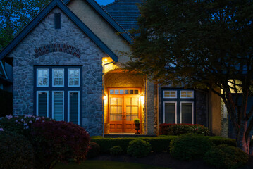 Entrance of luxury house with nice spring blossom landscape at night in Vancouver, Canada, North America. May 2025.