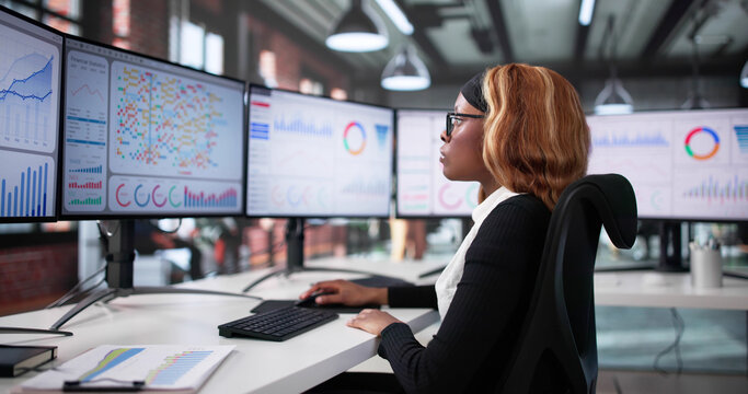 Black Businesswoman Analyzing Stock Market Data - Powered by Adobe