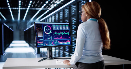 Young Woman In Data Center Controlling SCADA System
