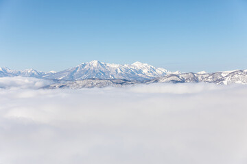 Lonely summit crowns misty heights