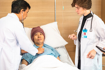 Asian man cancer patient visiting young female doctor for medical consultation in clinic. male patient struggling with cancer, healthcare. Medicine concept.Female doctor explaining xray to patient.