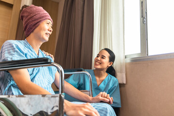Cancer man patients in wheelchairs receive rehabilitation treatment at clinic. Young female doctor medical therapy treatments.Young patient with a smiling and friendly expression.