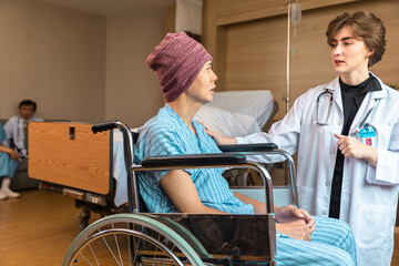 Cancer man patients in wheelchairs receive rehabilitation treatment at clinic. Young female doctor medical therapy treatments.Young patient with a smiling and friendly expression.