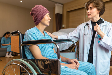 Cancer man patients in wheelchairs receive rehabilitation treatment at clinic. Young female doctor medical therapy treatments.Young patient with a smiling and friendly expression.