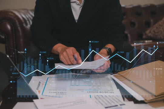 Man sitting in office or library analyse report data, using laptop for work or study data analysis in business or research on data charts
