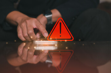 risk and cyber security technology concept, a man pointing at mobile phone with alert warning...