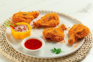 Raw crispy chicken thigh ready for frying.