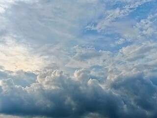  A breathtaking view of cumulus clouds forming in a partly sunny sky, offering a majestic yet calm natural background.