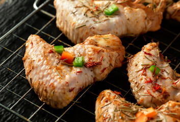Fresh raw marinated chicken wing.