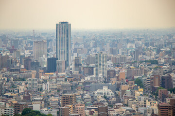 Fototapeta premium Nagoya cityscape seen from Higashiyama Tower on a clear day.Cityscape of Nagoya city overlooking from the sunny Higashiyama Tower.