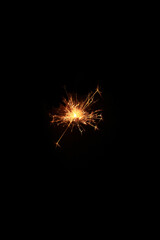 Yellow sparks fly on a black background, layered with grain, noise, and glowing effects to give a...