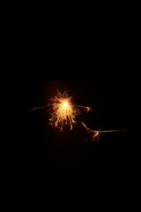 Yellow sparks fly on a black background, layered with grain, noise, and glowing effects to give a...