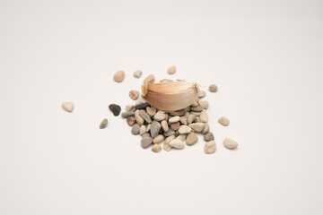 Photographic still life of garlic clove on pebbles for culinary content natural food photography style