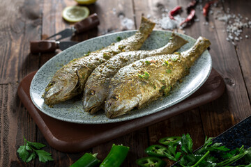 Raw marinated fish ready for grilling.
