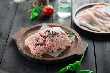 Frozen raw veal kofta in wooden plate.