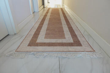 Long decorative rug enhances entrance hallway decor