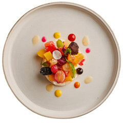 Gourmet fruit tart with assorted berry citrus and herb garnish