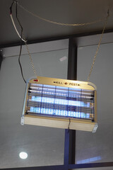 Pest control device hanging in modern indoor setting