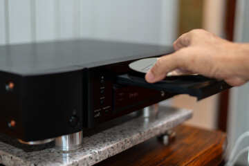 Fototapeta premium nserting CD into Audio Player