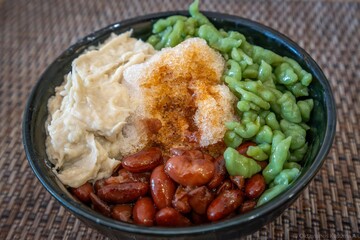 Refreshing Durian and Red Bean Cendol Ice Dessert in a Traditional Glass Bowl Served on Wooden Table