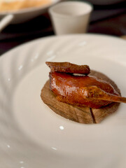 Roasted pigeon served on a porcelain plate in fine dining presentation