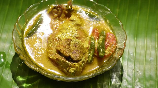 Steamed Mustard Hilsa, Bengali cuisine - Ilish bhapa is a classic preparation of Hilsa fish where the fresh fish is steamed in mustard, coconut and yogurt paste.