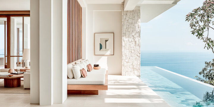 Luxurious coastal villa with infinity pool overlooking the ocean during sunny day