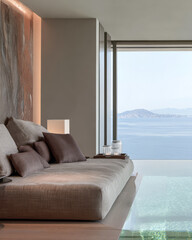 Modern living space with large windows overlooking serene ocean and mountains