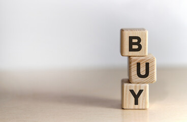 BUY - text on wooden cubes, on white background
