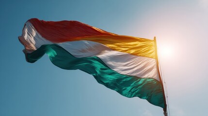 Tricolor flag waving in front of a clear sky